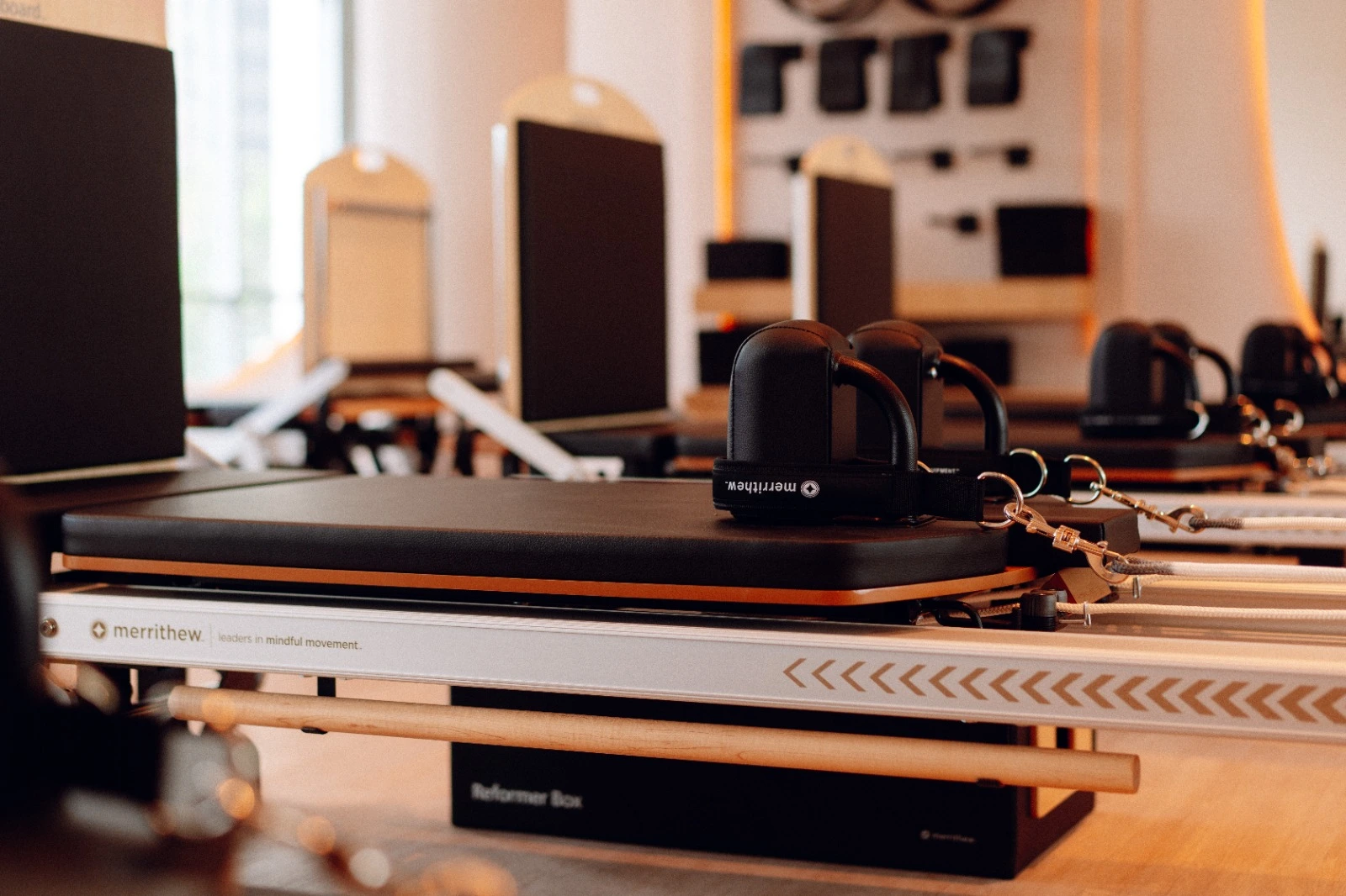 Woman using Pilates reformer at Aligné Studio